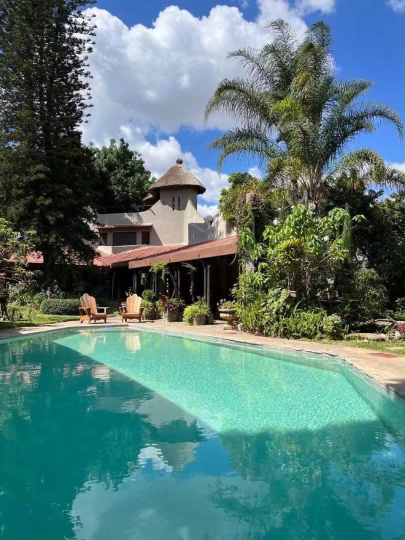 Swimming pool and garden at the listed five-bedroom Kalundu home